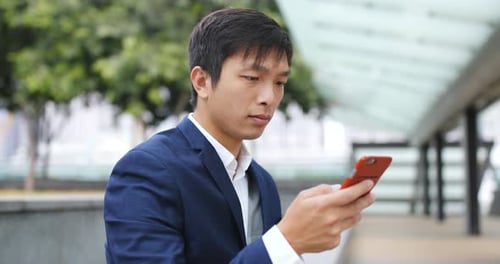 Young Adult Using Mobile Phone in the City