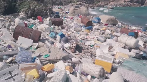 Environmental destruction caused by beach covered in plastic and rubbish causing climate change in H