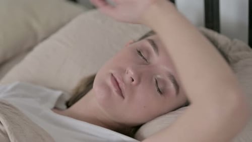 Woman Sleeping Peacefully in Bed at Home