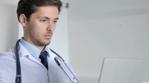 Close Up of Doctor Working On Laptop in Clinic