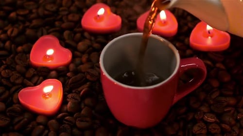 Pouring Coffee into Cup Surrounded by Heart Candles