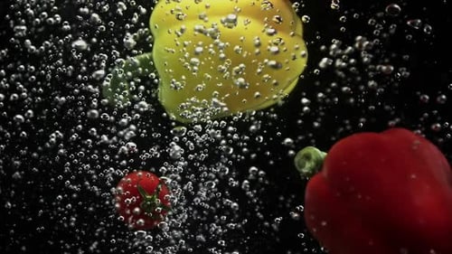Vegetables Dropping into Water in Slow Motion