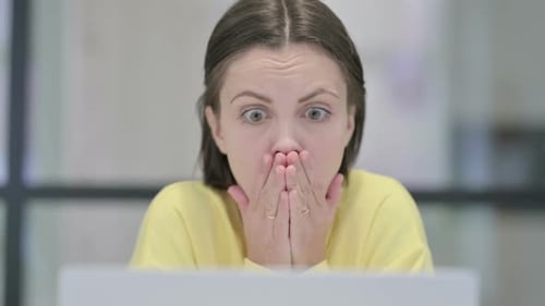 Close Up of Woman Reacting to Loss on Laptop