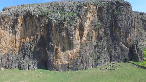 Fortress On The Mountain Summit With High Cliff Rocky Wall