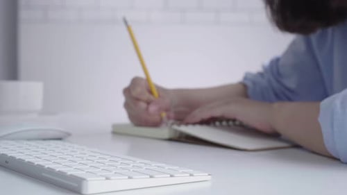 Young Adult Typing on White Keyboard