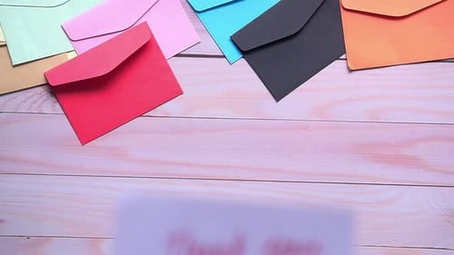 Colorful Envelopes and Thank You Note on Table