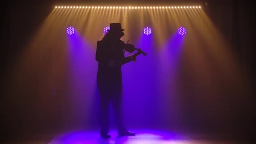 Violinist Playing Violin on a Dark Stage