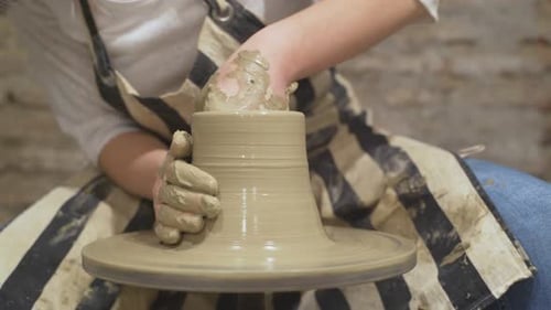 Hands Shaping Clay on Pottery Wheel