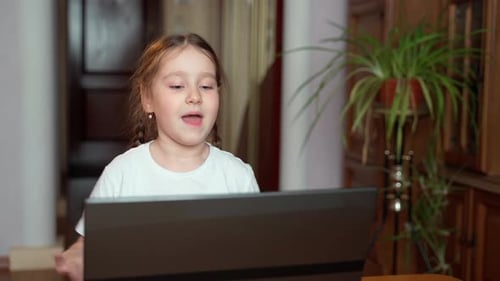 Girl Singing and Talking on Laptop at Home