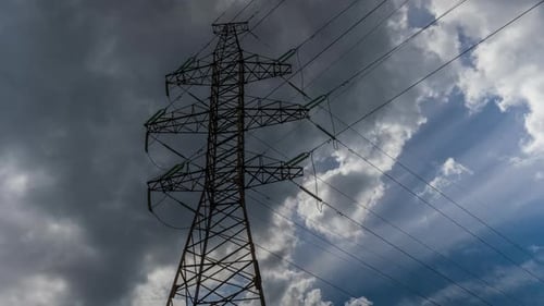 Towering Transmission Tower against Dramatic Cloudscape