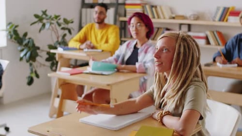 Female Student Asking Senior Professor during College Lecture