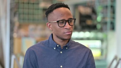 Positive Casual Young Man Using Smartphone