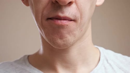 Unrecognizable Man Bites Cookies and Chews
