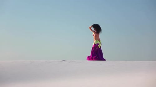 Woman Dancing Belly Dance on White Desert Sand