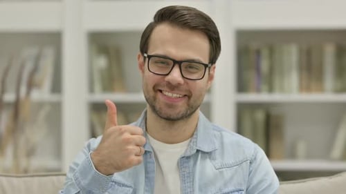 Smiling Young Adult Gives Thumbs Up