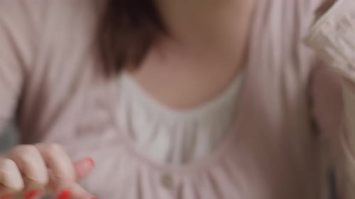 Worried Woman Counting Coins at Home