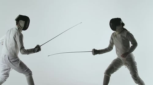 Two Professional Fencers Show Masterful Swordsmanship in Their Foil Fight. They Dodge, Leap and