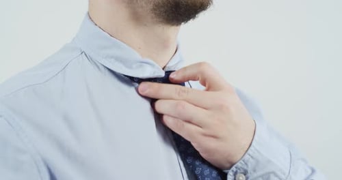 Man fixing his tie