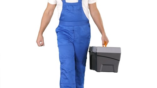 Person Walks Carrying Toolbox in Blue Overalls