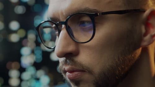 Close-up portrait of a young man working at the computer.