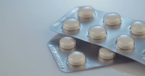 Prescription drugs - Capsules, pills, tablets on reflective background
