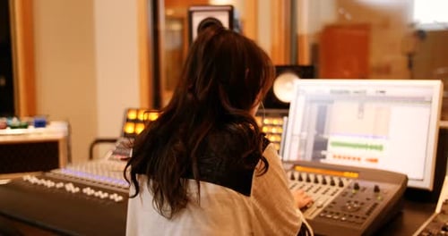 Female audio engineers using sound mixer