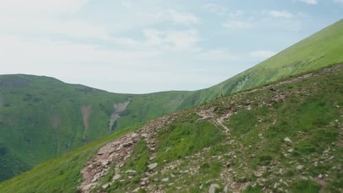 Aerial View of a Group of Young Tourists Walking Along a Mountain Trail to the Top of the Mountain