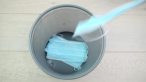 Surgical Masks Thrown in Trash Can, Top-Down View