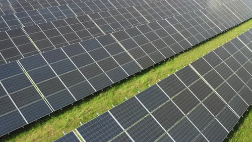 Solar Panels Stretching Across Field on Sunny Day