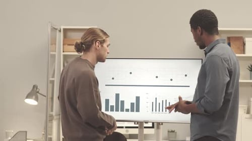 Team Discussing Data Analytics on Interactive Display