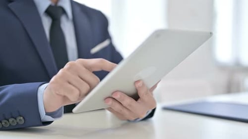 Close Up of Businessman Using Tablet