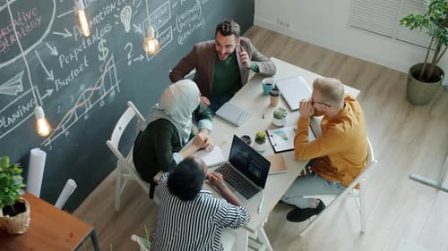 Joyful Employees Getting Good News on Mobile Phone Laughing Doing Highfive in Office