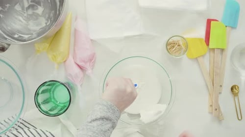 Step by step. Flat lay. Mixing royal icing to decorate Easter sugar cookies