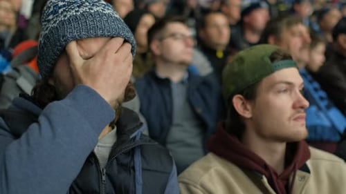 Portrait Tired Hockey Fan Boring Game Closeup in Crowd Stadium Rub Face Hand