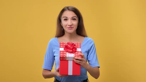 Happy Woman Holding Stack of Beautifully Wrapped Gifts