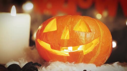 Scary spooky face on carved pumpkin glowing inside. Halloween