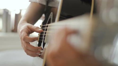 Hands Playing Acoustic Guitar Close Up