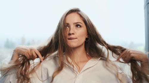 Beautiful Woman Smiling and Tossing Her Wavy Hair
