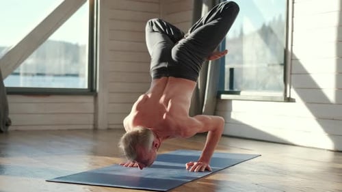 Muscular Senior Man Practicing Yoga at Home