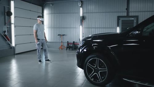 Male Mechanic Diagnosing Car in VR Headset