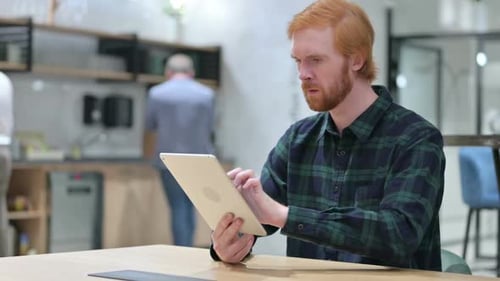 Man Reacts Positively to Tablet in Office Setting