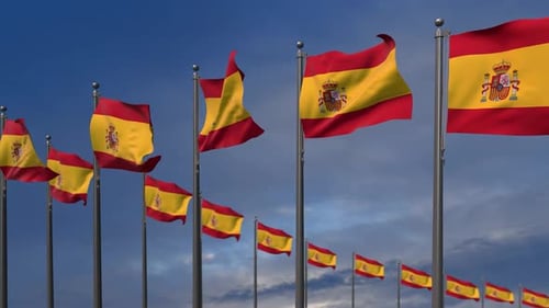 Realistic Multiple Spanish Flags Waving Under Blue Sky