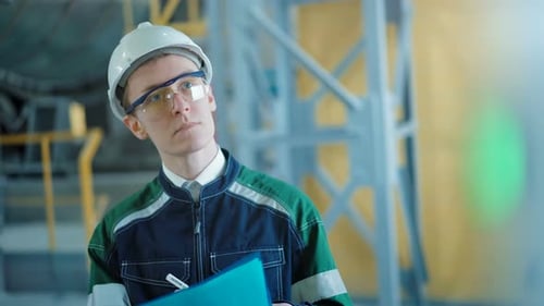Engineer Signing a Document in Industrial Factory