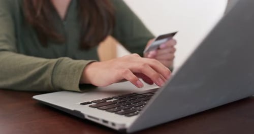 Woman Using Laptop with Credit Card for Payment