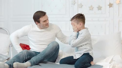 Man Gives Gift to Boy in Bedroom