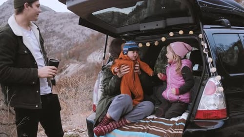 Family Enjoying Roadside Picnic in Mountains