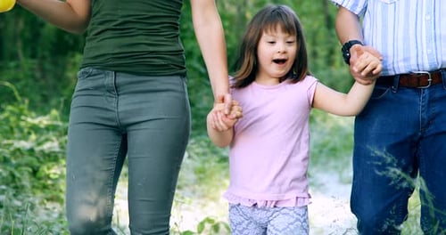 Family Walking Together Holding Hands Outdoors
