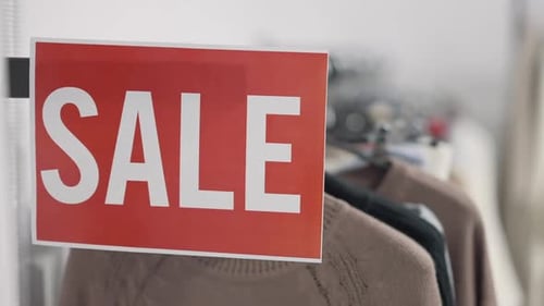 Closeup Sale Announcement in Clothing Shop Indoors