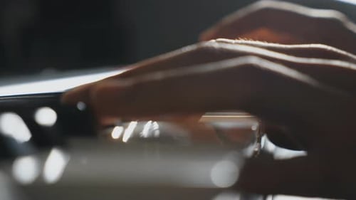 Fingers of Pianist Pressing at the Black and White Piano Keys