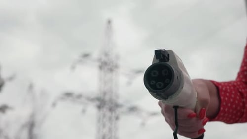 Electric Vehicle Charging Plug Close-Up in Rural Setting